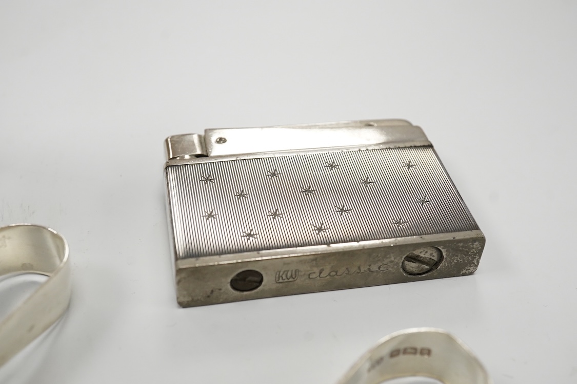 A collection of small silver to include a cigarette case, two napkin rings, three pairs of sugar tongs, a thimble, a lady's wrist watch and a mounted glass toilet jar. together with a 925 fob watch, a 935 mounted lighter